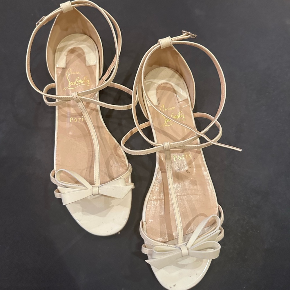 Christian Louboutin Cream Sandals with Sleek Straps and Signature Red Sole